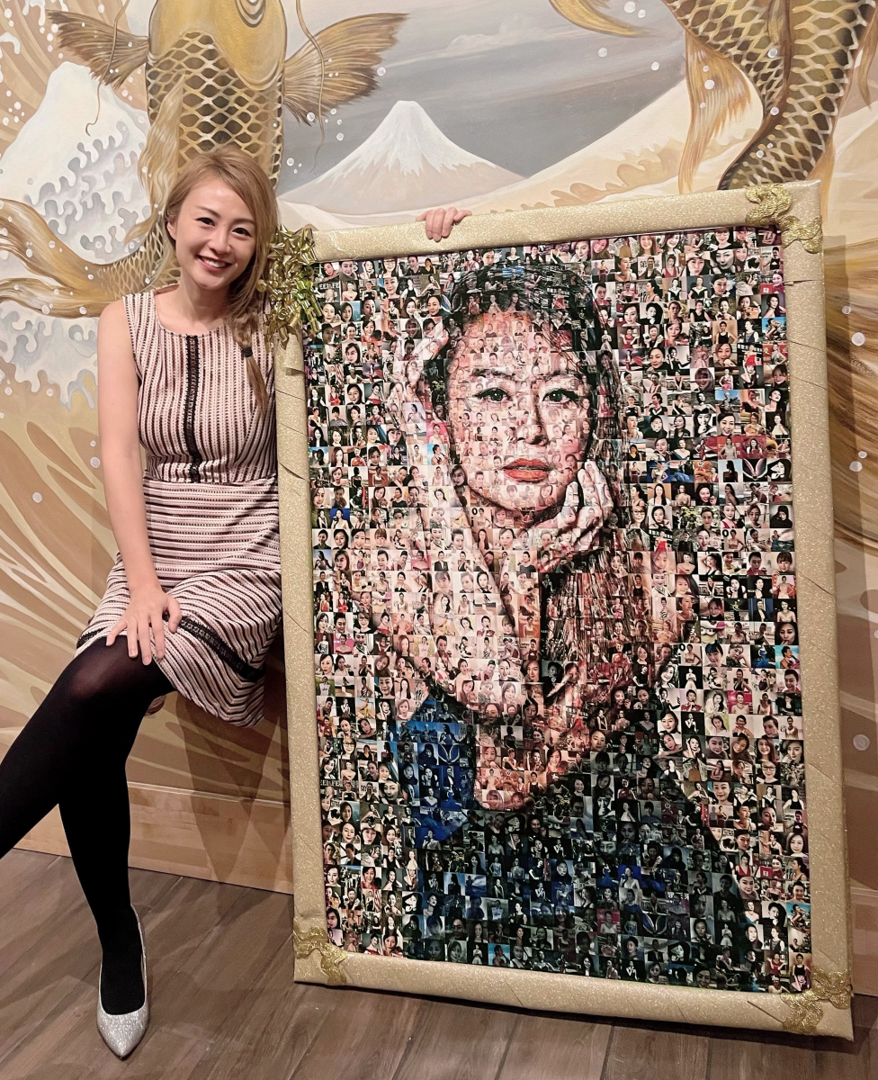 a women in her twenties, sitting next to her self-portrait  60x40" framed mosaic